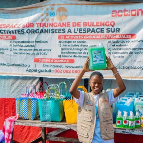 Psycho-social Assistant, Esther Igunzi Johnson, proudly showcases products crafted by project participants, empowering them to generate income and build brighter futures with ActionAid DRC