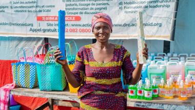 Mama Ariette HATEGEKA, a womens leader, proudly displays products produced by project beneficiaries